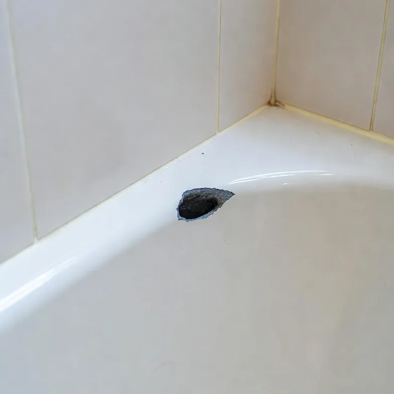 Chipped porcelain bathtub before repair